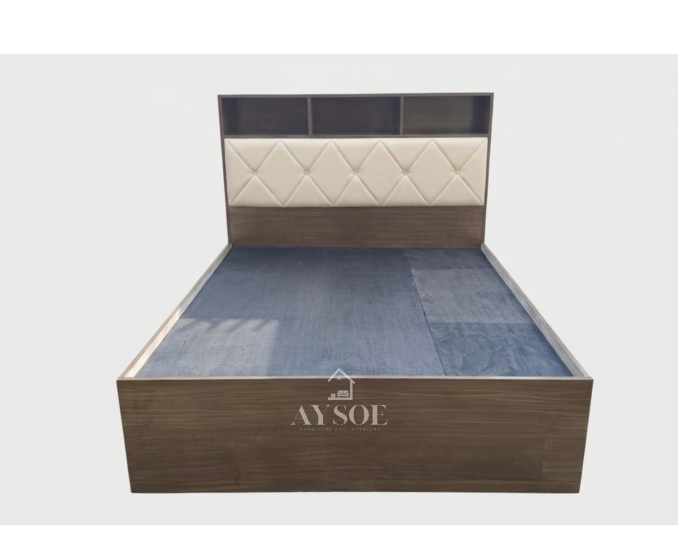 A platform bed in a dark wood-grain finish, with a shelf headboard, a cream tufted cushion panel, and two roomy side drawers. Built-in storage for small rooms.