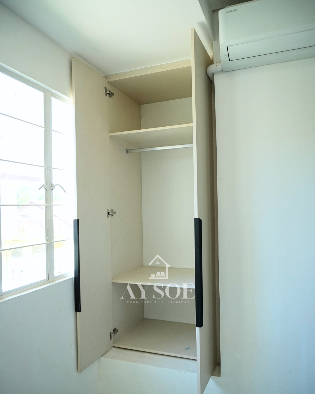 A custom bedroom set in a cream linen-texture finish, with a built-in study desk with two drawers and two wardrobes with hanging rods and shelves. Complete storage and a work spot for small rooms.