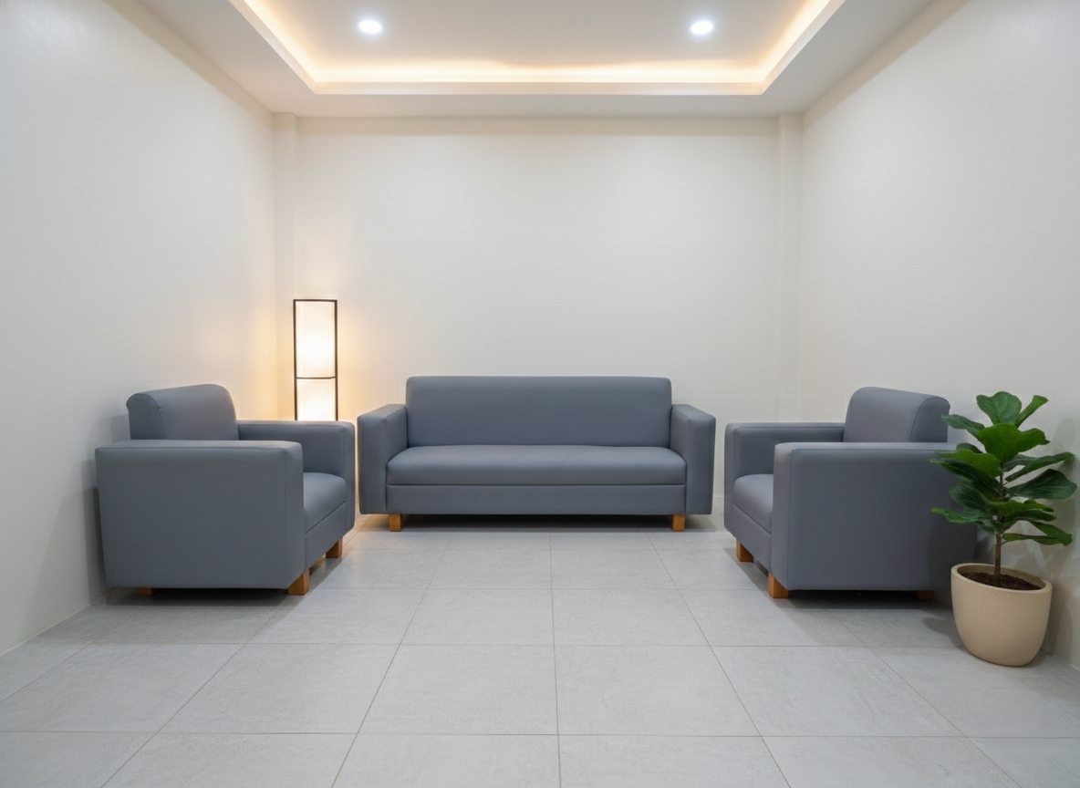 The Seating Arrangement: A long 3-seater sofa anchors the back wall, flanked symmetrically by two large, deep matching single-seater armchairs facing inward.