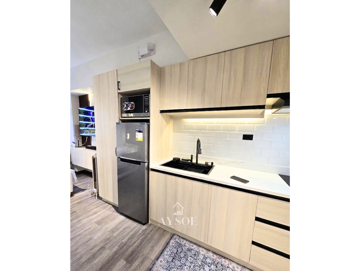 A modern straight kitchen cabinet set in a light oak wood-grain finish, with upper and lower cabinets, three drawers, and a tall pantry tower. Clean, bright, and space-saving.