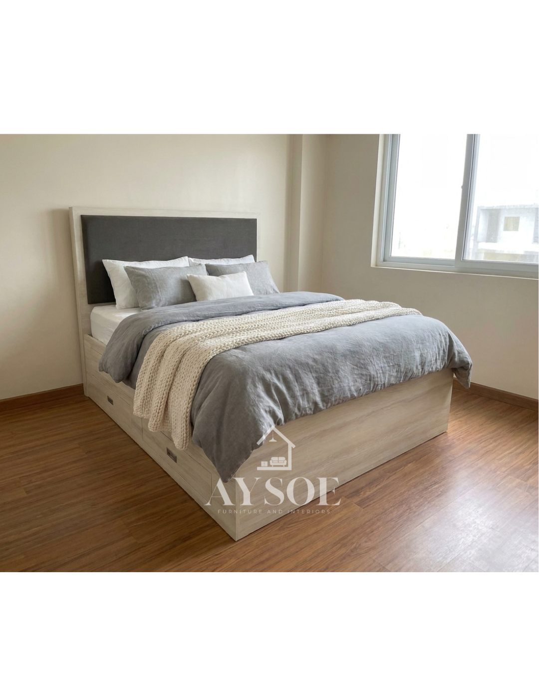 A light oak storage bed with a lift-up platform, four side drawers, and a padded grey headboard. Huge hidden storage for bedding, clothes, and extras.