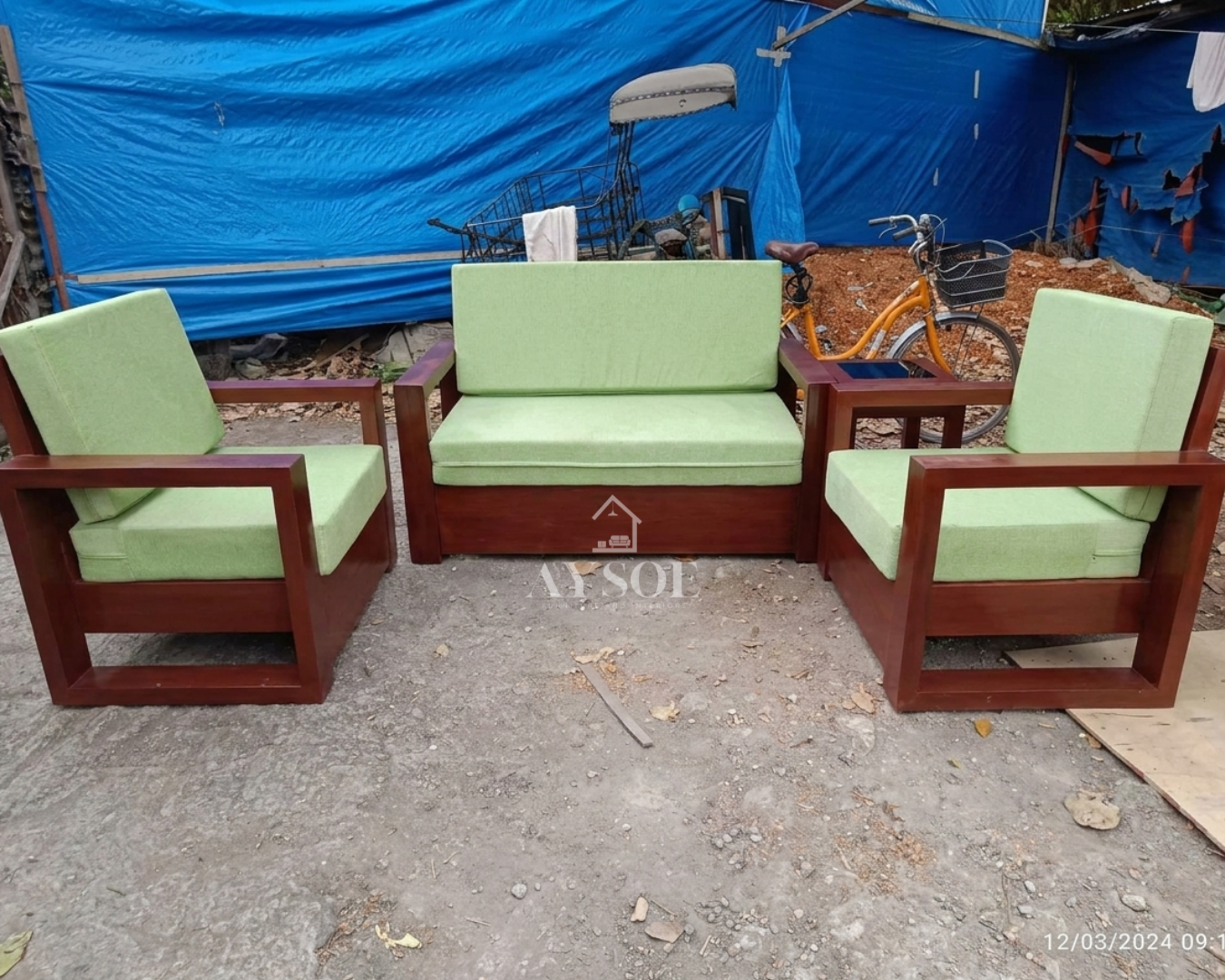 A compact 3-piece living set with a deep mahogany-finish solid wood frame and bright lime-green cushions: a two-seater loveseat and two matching armchairs.