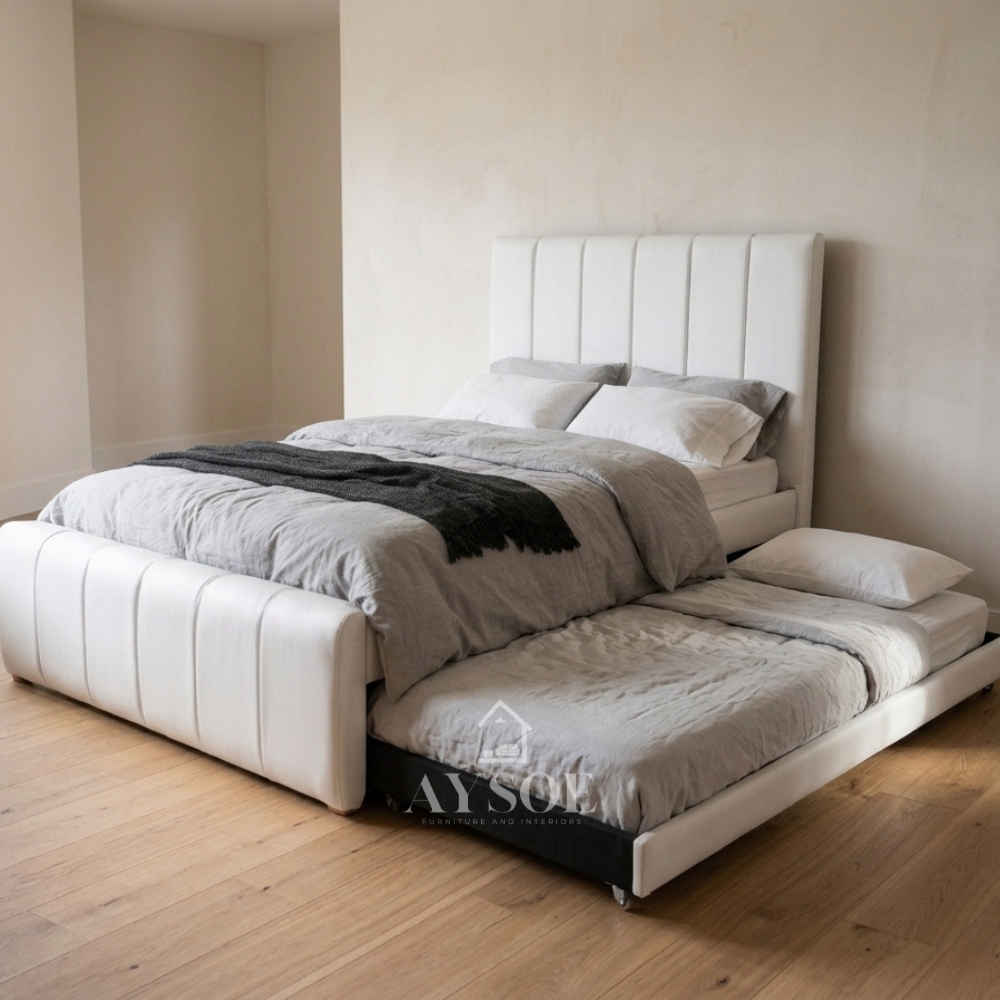 White leatherette bed with a vertical channel headboard and footboard. Hidden pull-out bed on wheels slides out from either the left or right side to suit your room.