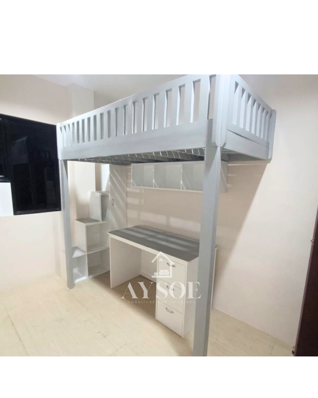 A white solid wood loft bed with a built-in study desk, three drawers, stepped cube shelves, and an overhead shelf underneath. A bed, desk, and storage in one footprint.