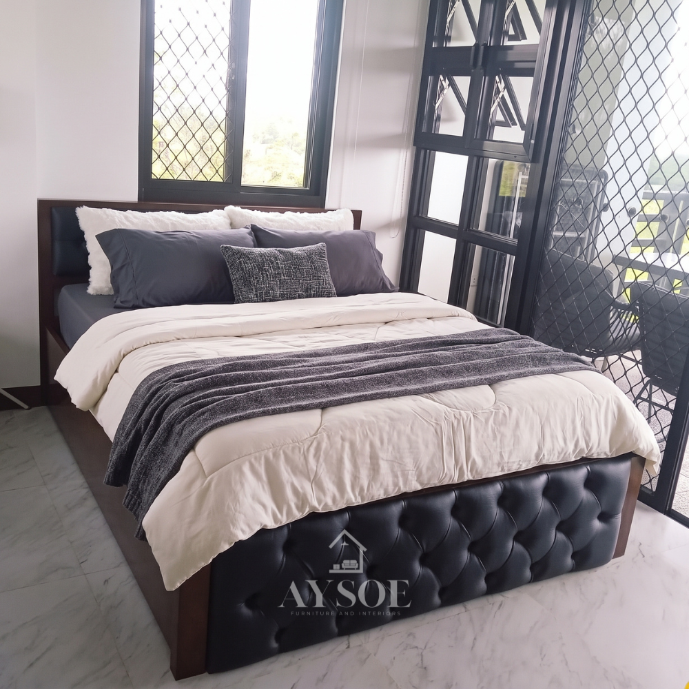 A solid wood bed in a rich, glossy dark walnut finish, with a black button-tufted leatherette headboard panel, a matching tufted footboard, and a sturdy slatted base. Bold, classic, and built to last.