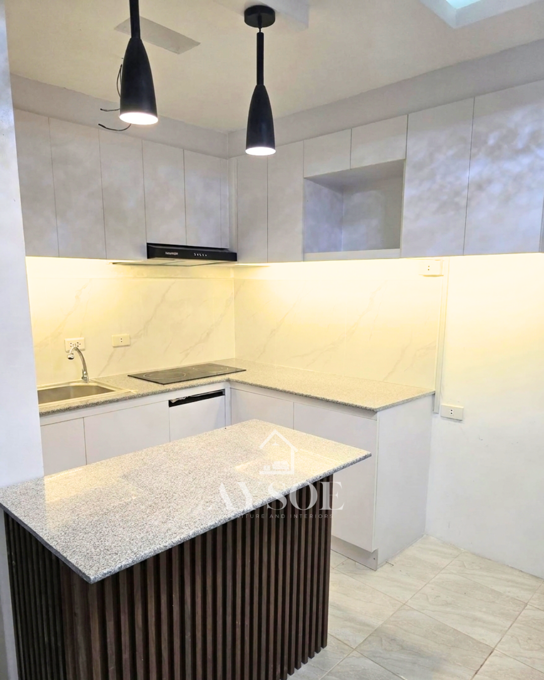 A modern L-shaped kitchen set with handleless grey marble-look cabinets, a granite-look countertop, and a fluted walnut island. Bright, roomy, and ready for cooking and entertaining.