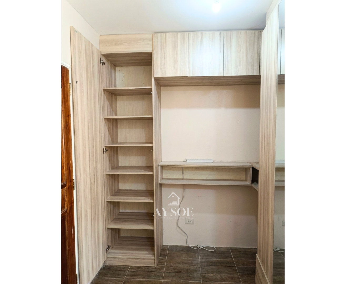 A custom light oak storage set with a tall shelf cabinet, three overhead cabinets, and a wall-mounted floating desk. Smart storage and a work spot for small rooms.