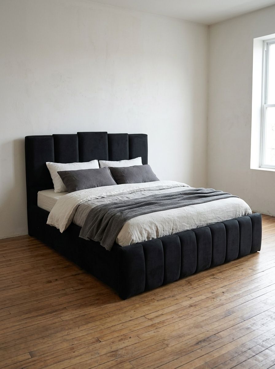 A bold black velvet-style bed with a tall headboard of five raised vertical panels in staggered heights, a channel-paneled footboard, and a fully wrapped frame. Dramatic, modern, and made to stand out.