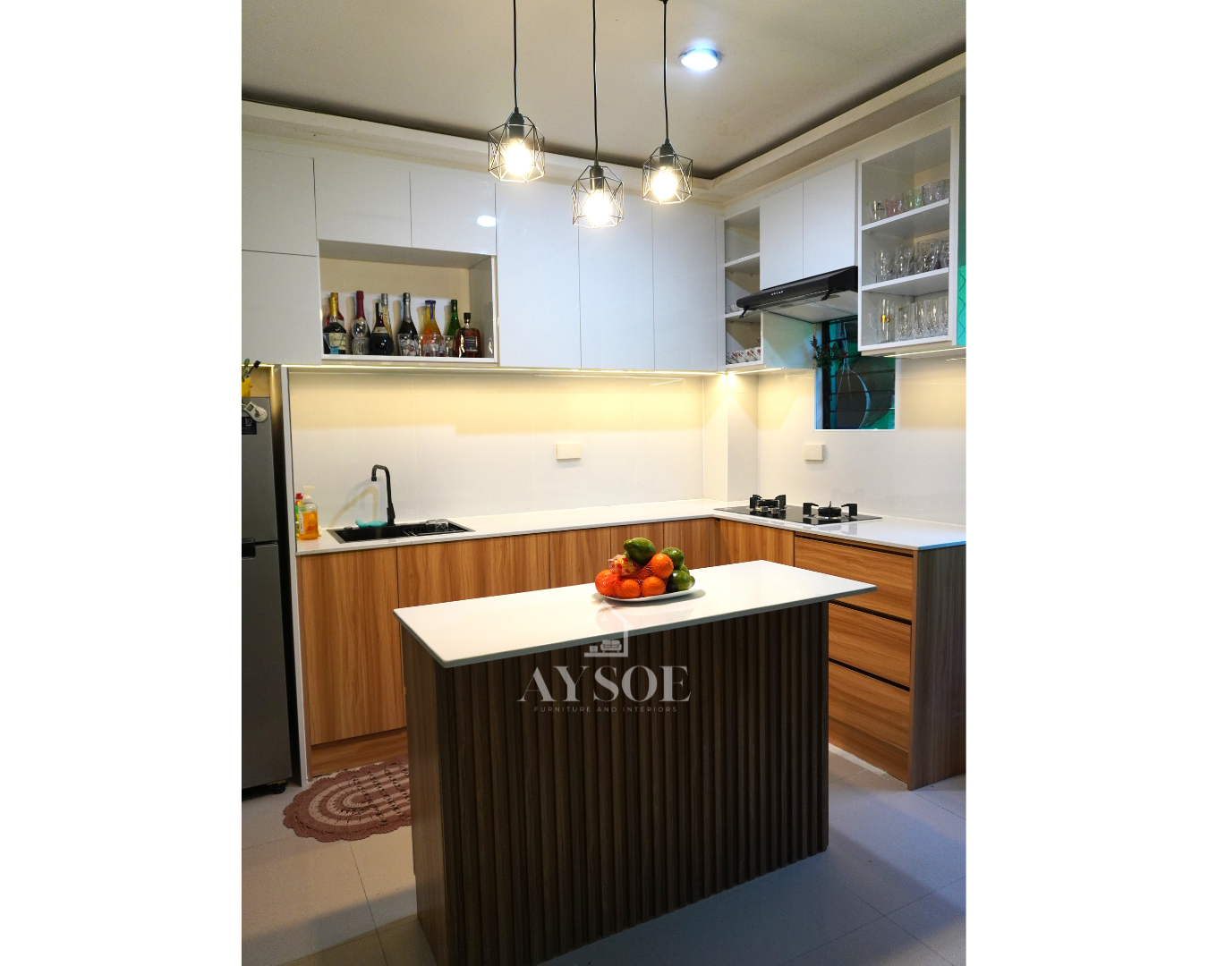 Custom-built kitchen cabinets with glossy white uppers, warm wood-grain base cabinets, and a fluted-panel island, designed for smart storage and a warm, modern look.