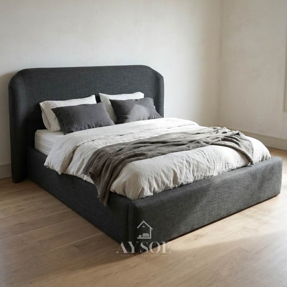 A king-sized charcoal fabric bed with a tall, curved headboard. Available in all sizes, in fabric or leather, with optional storage or a pull-out bed.