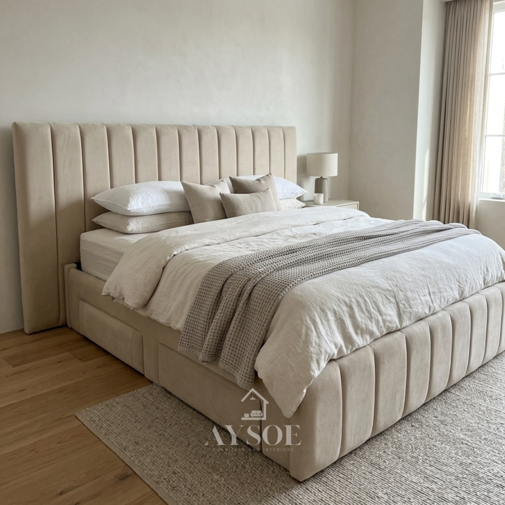 Sand-beige fabric storage bed with a vertical channel headboard, matching footboard, and four upholstered side drawers. Available in various sizes, in fabric or leather.