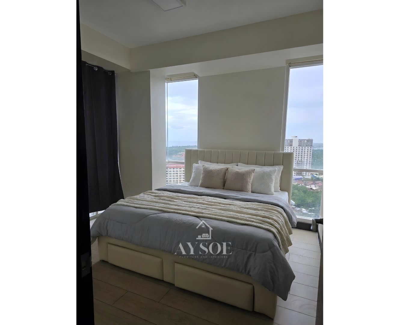 An upholstered bed frame in soft cream leatherette, with a channel-tufted headboard and two roomy pull-out drawers. Clean, modern, and space-saving.