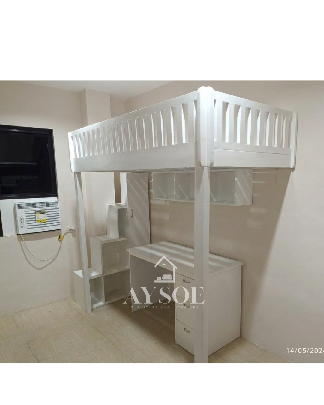 A white solid wood loft bed with a built-in study desk, three drawers, stepped cube shelves, and an overhead shelf underneath. A bed, desk, and storage in one footprint.