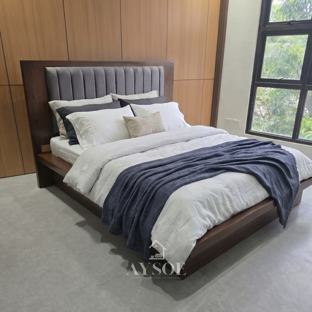 A modern dark walnut platform bed with a wide wood ledge, a recessed base for a floating look, and a tall wood headboard with a soft gray channel-tufted panel. Clean, solid, and built to last.