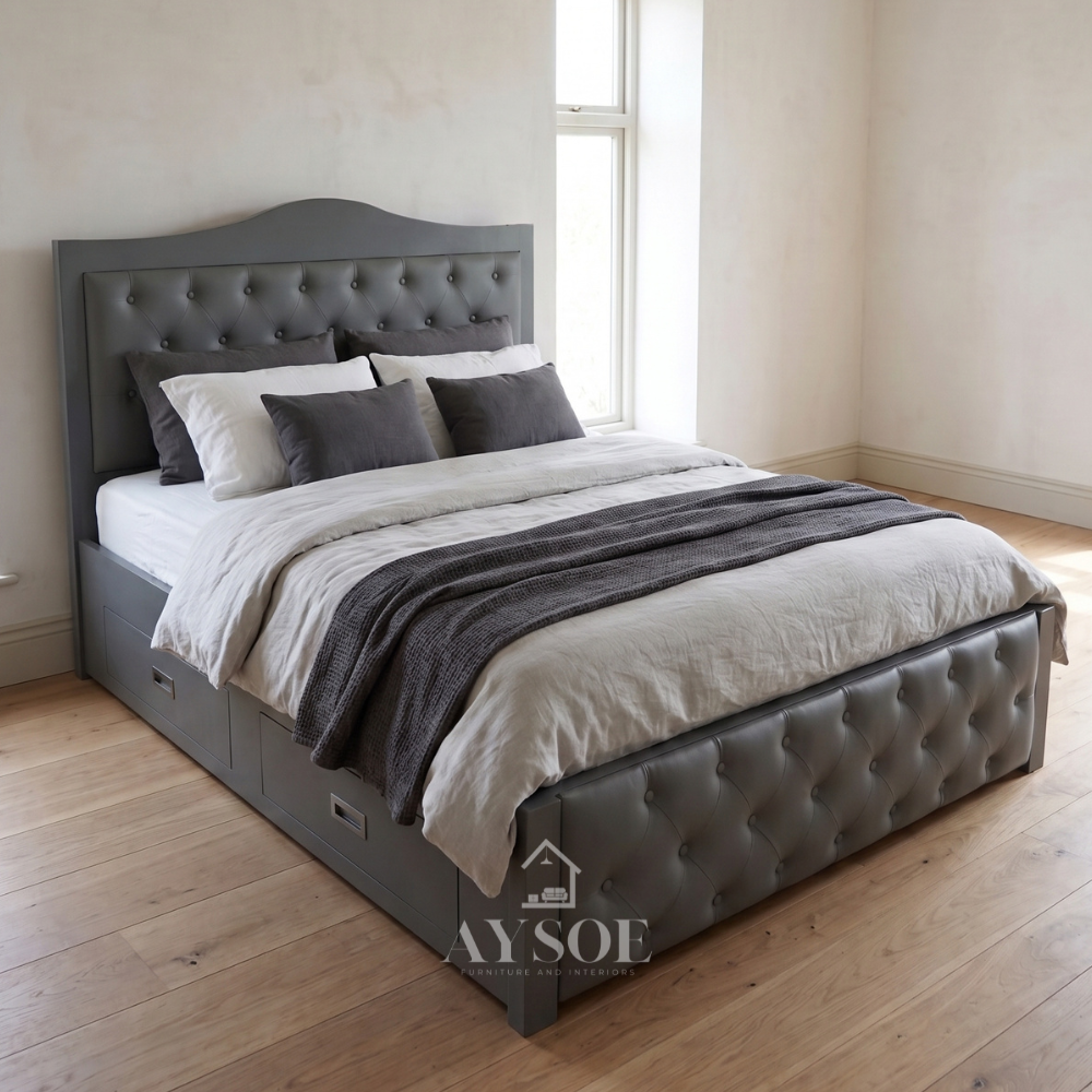 A classic storage bed in soft slate gray, with an arched wood-framed headboard, button-tufted leatherette panels on the headboard and footboard, and built-in side drawers with recessed metal pulls.