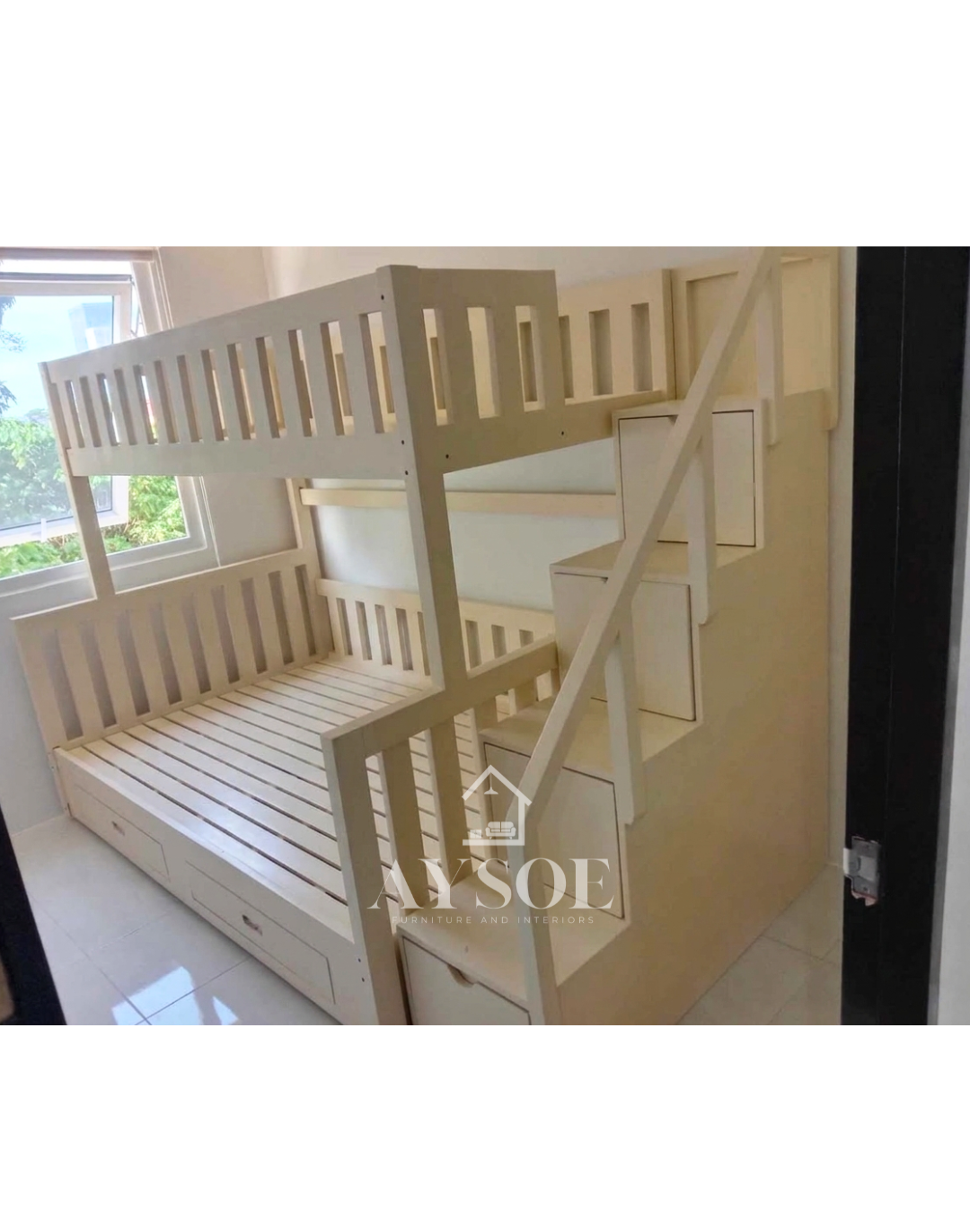 A cream white solid wood bunk bed with a single upper bunk, a wider lower bed, a staircase with four storage drawers, and two more drawers under the bed. Sturdy and space-saving for shared rooms.