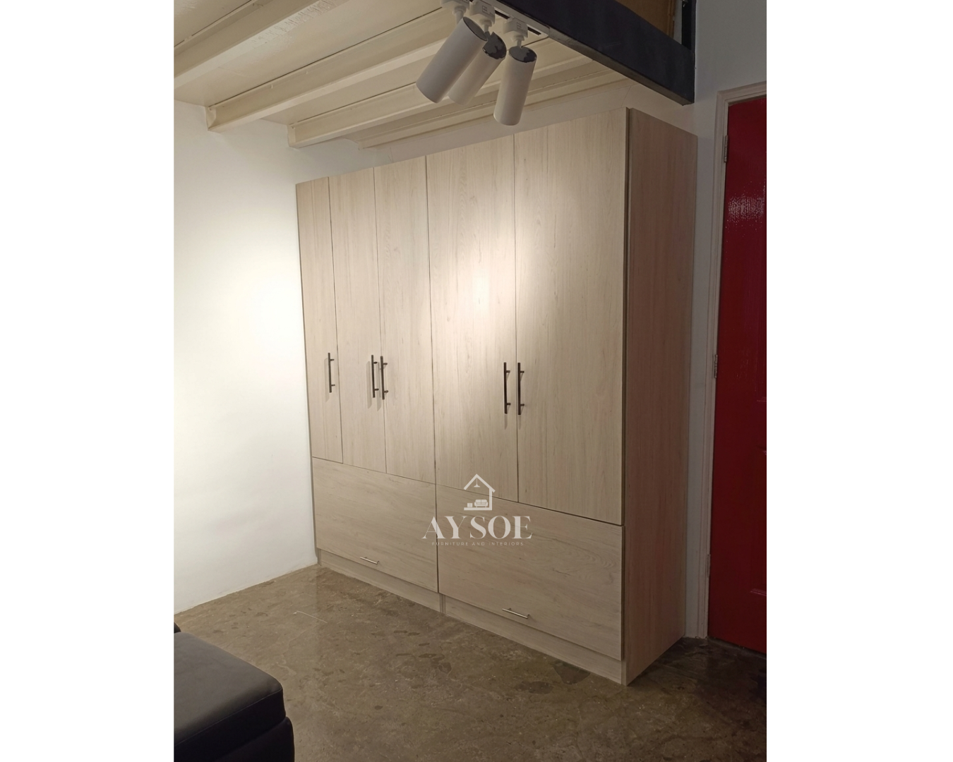 A custom light oak wardrobe with a hanging rod, six cube shelves, and two roomy bottom drawers. Organized storage for clothes, shoes, and linens.