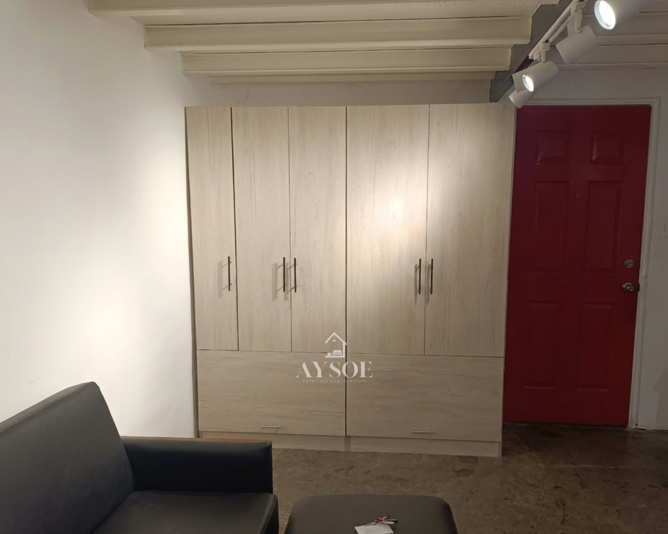 A custom light oak wardrobe with a hanging rod, six cube shelves, and two roomy bottom drawers. Organized storage for clothes, shoes, and linens.