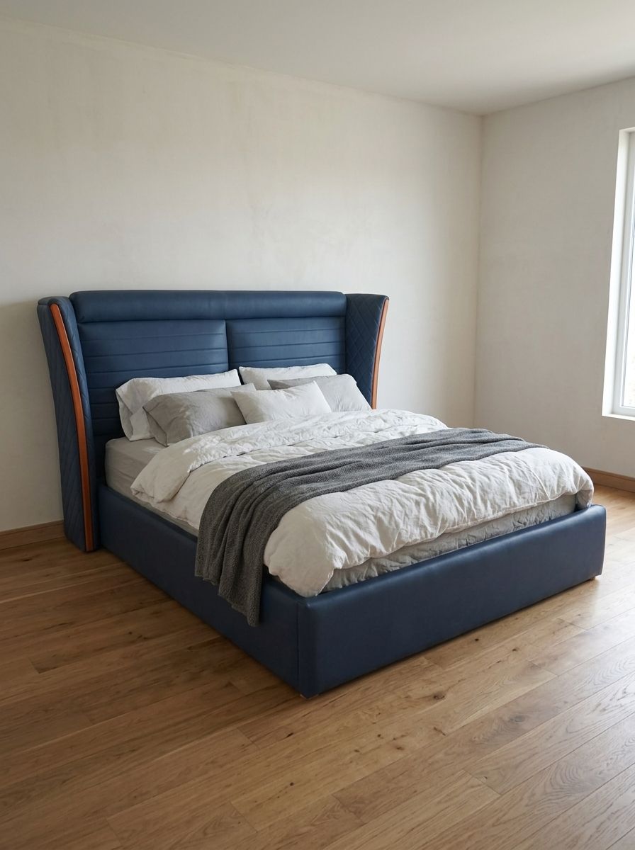 A bold navy blue leatherette bed with a tall curved wingback headboard, horizontal channel panels, and quilted diamond-stitch wings edged in warm wood. Clean, fully wrapped frame with a solid platform base.