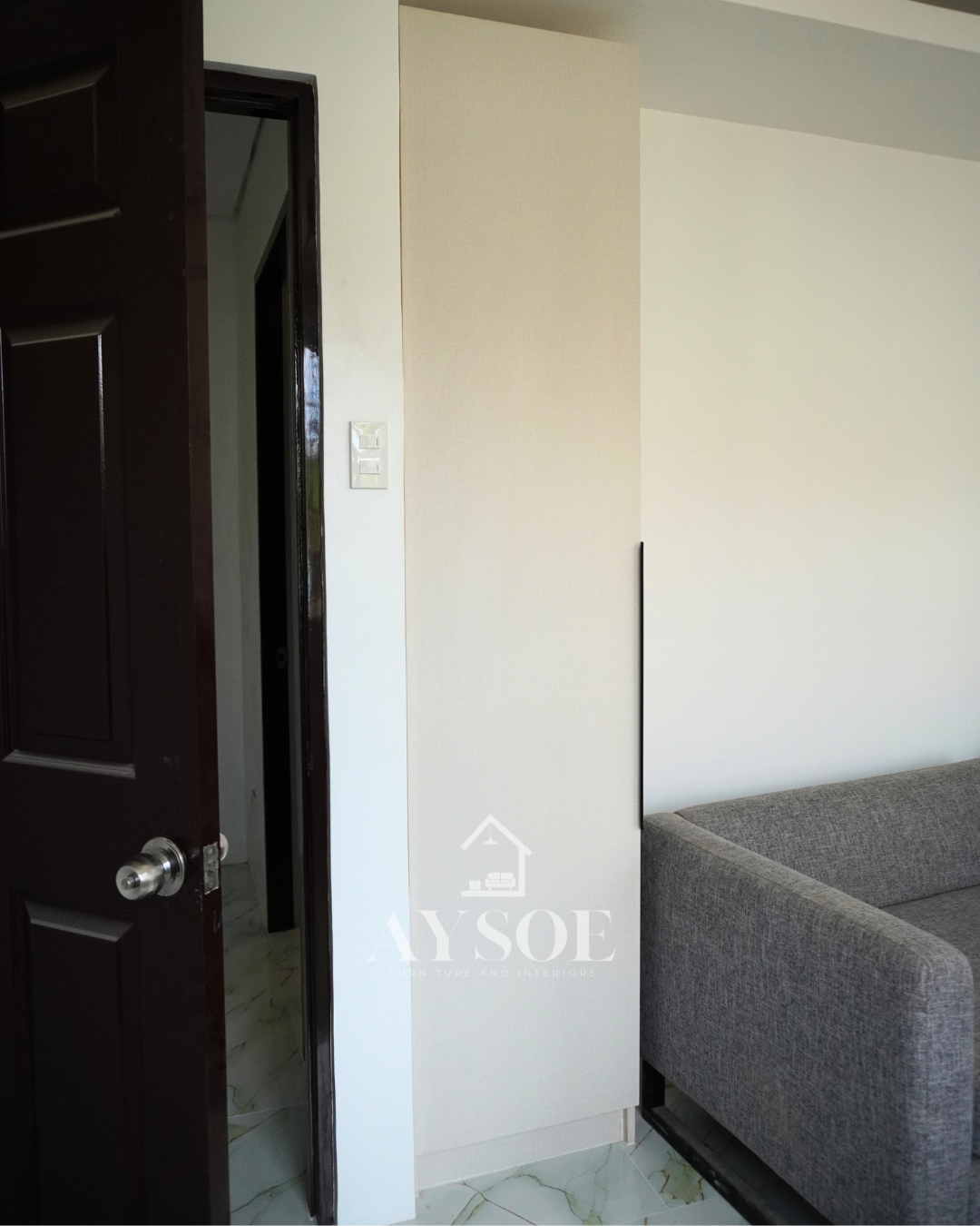 A custom bedroom set in a cream linen-texture finish, with a built-in study desk with two drawers and two wardrobes with hanging rods and shelves. Complete storage and a work spot for small rooms.