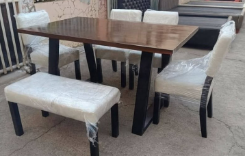  A combination seating arrangement consisting of four upholstered chairs and one matching upholstered bench.