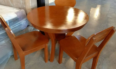 Three matching wooden dining chairs with smooth, curved solid wood backrests and square seats.