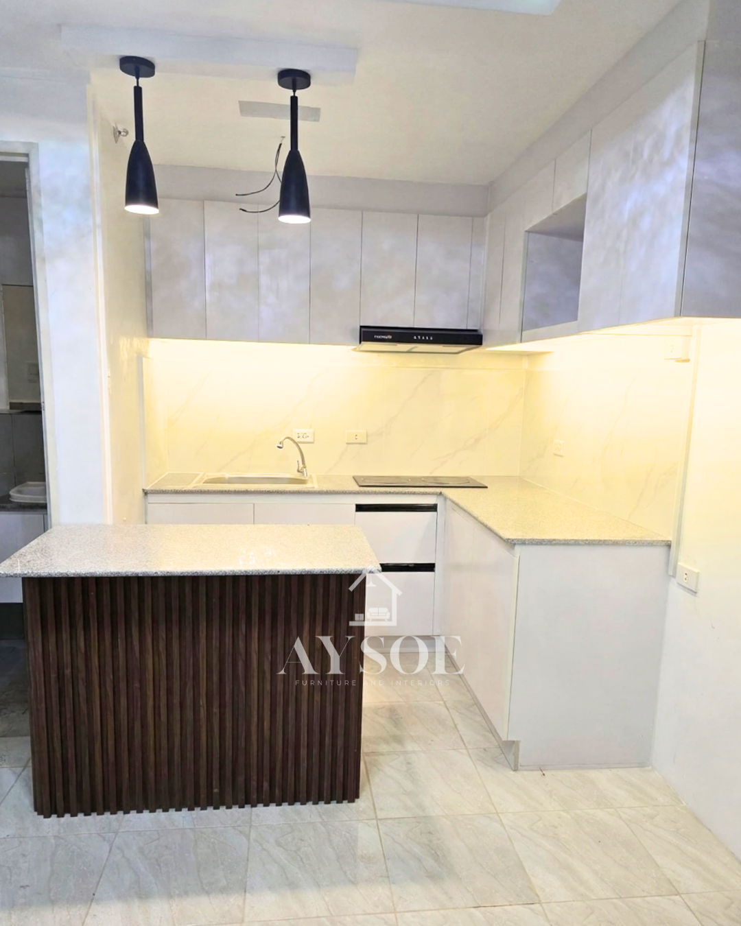 A modern L-shaped kitchen set with handleless grey marble-look cabinets, a granite-look countertop, and a fluted walnut island. Bright, roomy, and ready for cooking and entertaining.