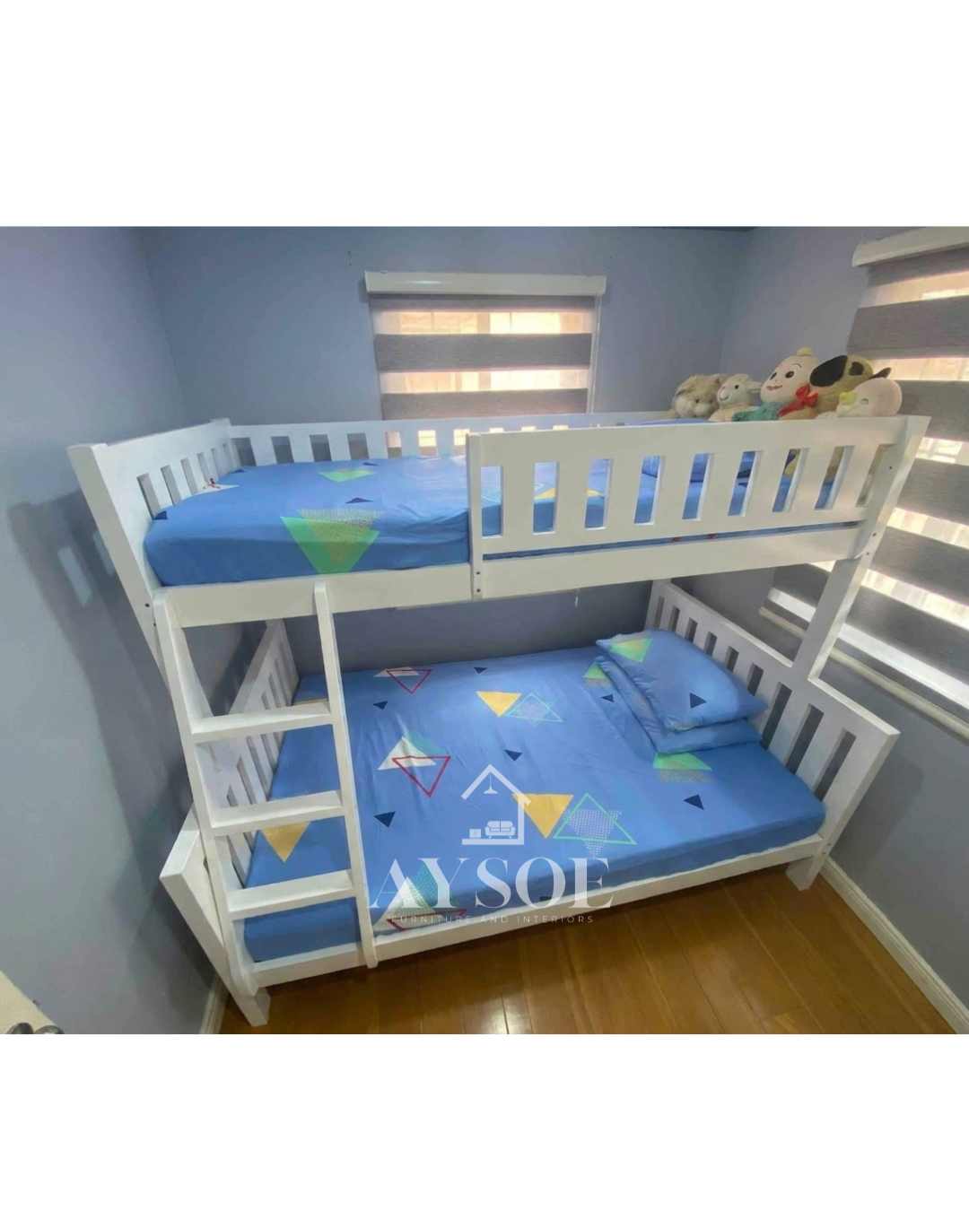 A white solid wood bunk bed with a single upper bunk, a wider lower bed, slatted guard rails, and a side ladder. Sturdy, clean-looking, and space-saving for shared rooms.