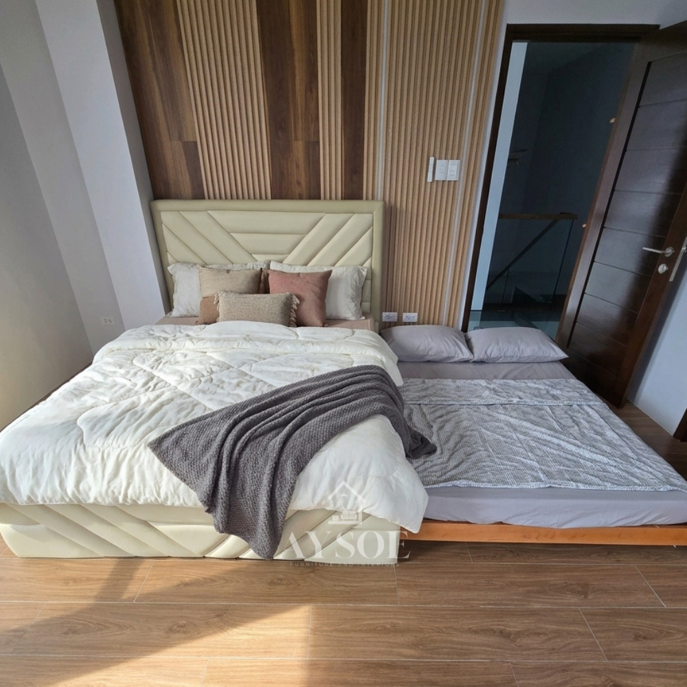 Cream leatherette bed with a geometric chevron headboard and matching footboard. Hidden pull-out trundle adds a second sleeping space. Available in various sizes, in fabric or leather.