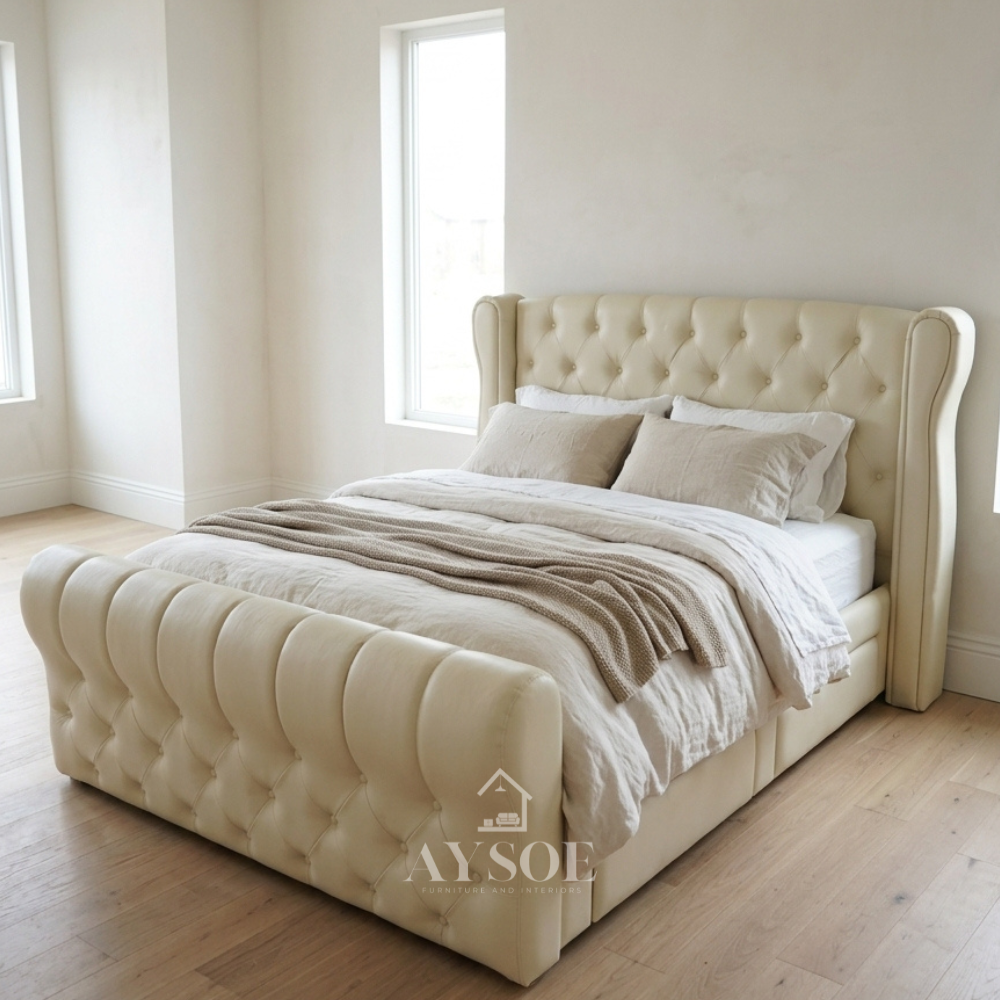 Cream leatherette bed with a tufted wingback headboard, sleigh footboard, and four side drawers. Easy to clean. Available in various sizes, in fabric or leather.