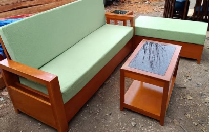 The package includes a matching two-tiered wooden center table in the middle and a matching square wooden side table placed between the sofa and the bench. 