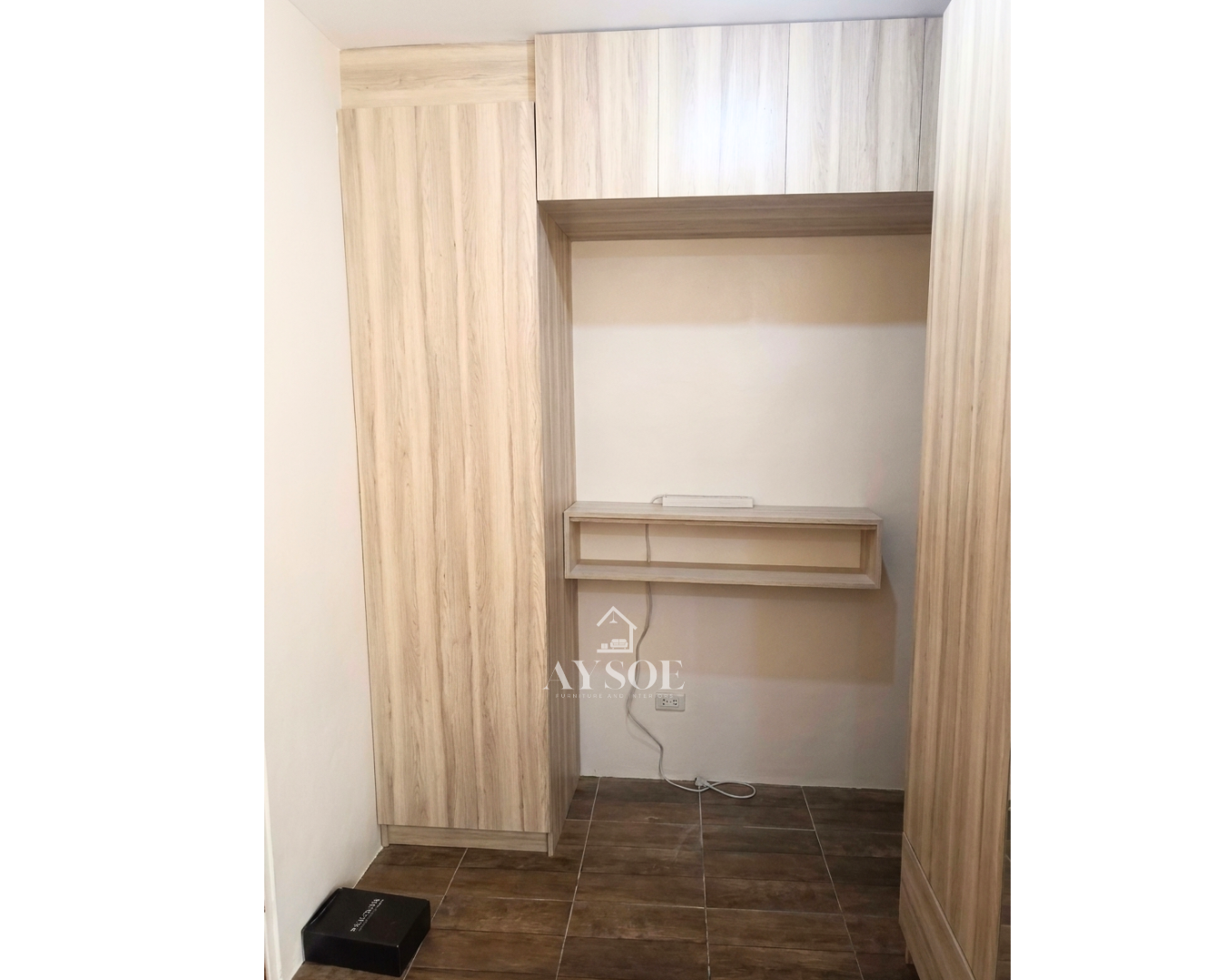 A custom light oak storage set with a tall shelf cabinet, three overhead cabinets, and a wall-mounted floating desk. Smart storage and a work spot for small rooms.