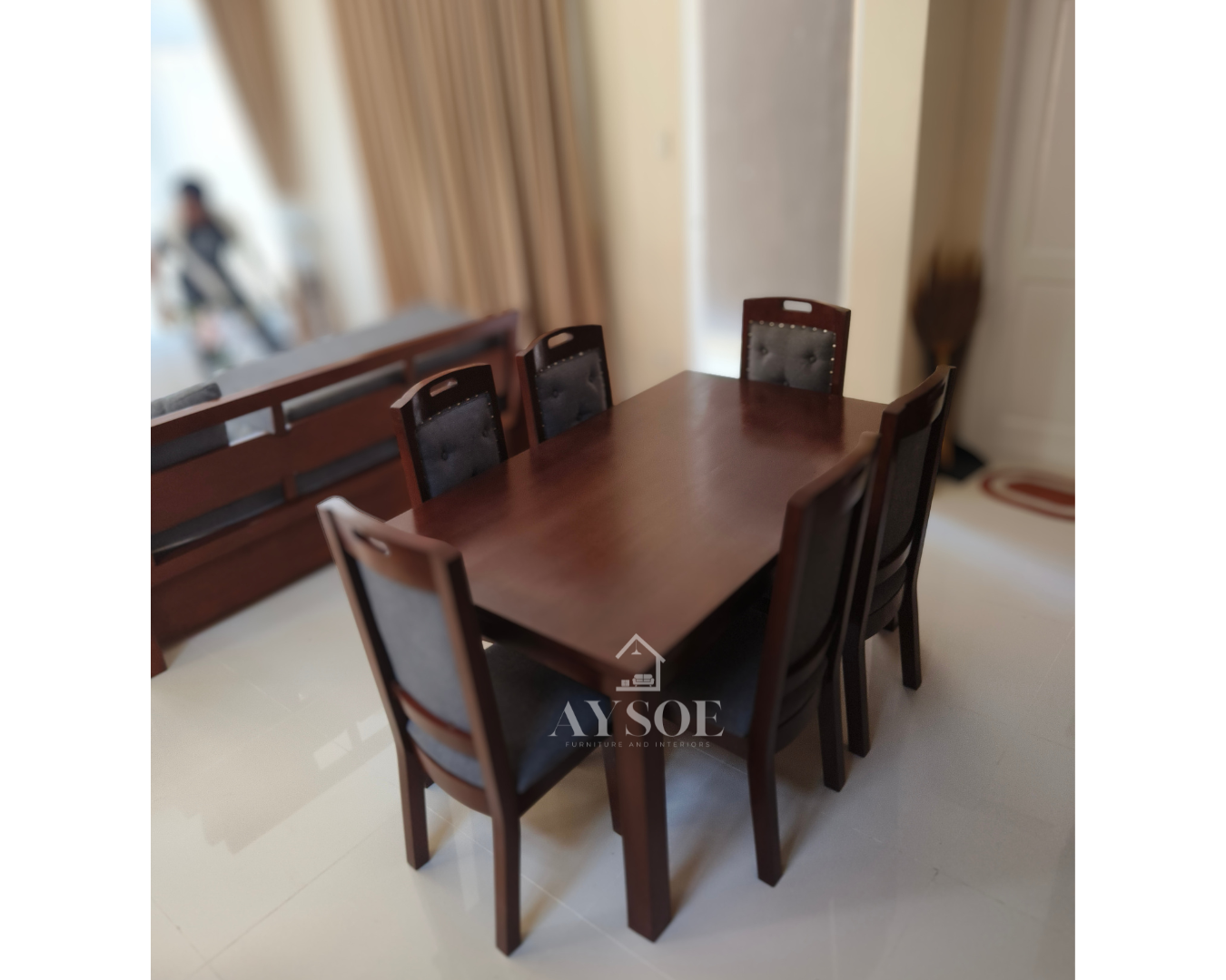 A 6-seater dining set with a solid wood table in a glossy mahogany finish and six upholstered high-back chairs with grey fabric seats and backs. Sturdy, comfortable, made to order.