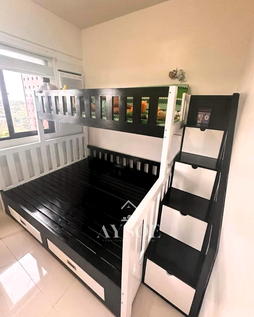A black and white solid wood bunk bed with a single upper bunk, a wider lower bed, a staircase with four storage drawers, and two more drawers under the bed. Sturdy and space-saving for shared rooms.