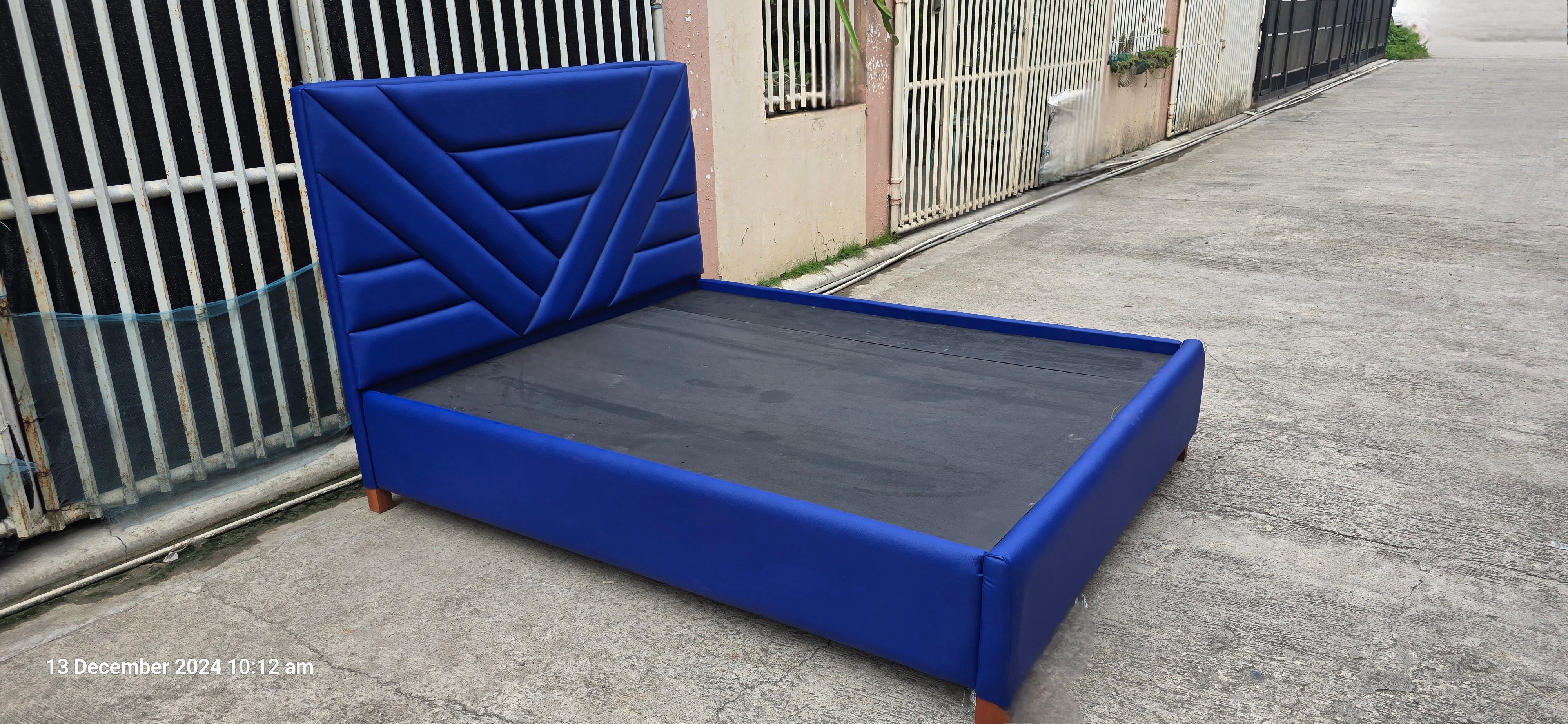 Constructed from a mahogany wood bed frame and upholstered with leatherette.