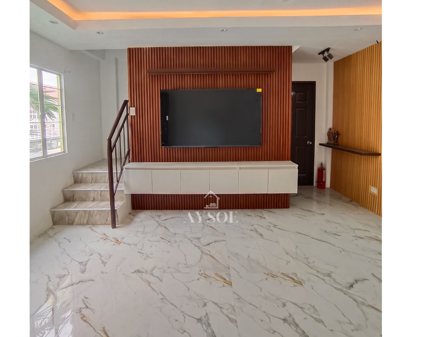 A floating white console with handleless doors, set against a warm walnut fluted wall. Finished with a slim display ledge and a matching oak slat accent wall.