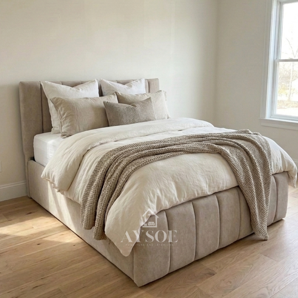 Light gray fabric bed with vertical channel panels on the headboard and footboard. Solid wood slatted base gives firm mattress support. Available in various sizes, in fabric or leather.