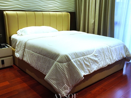 Queen bed frame in dark walnut, in a Talisay home