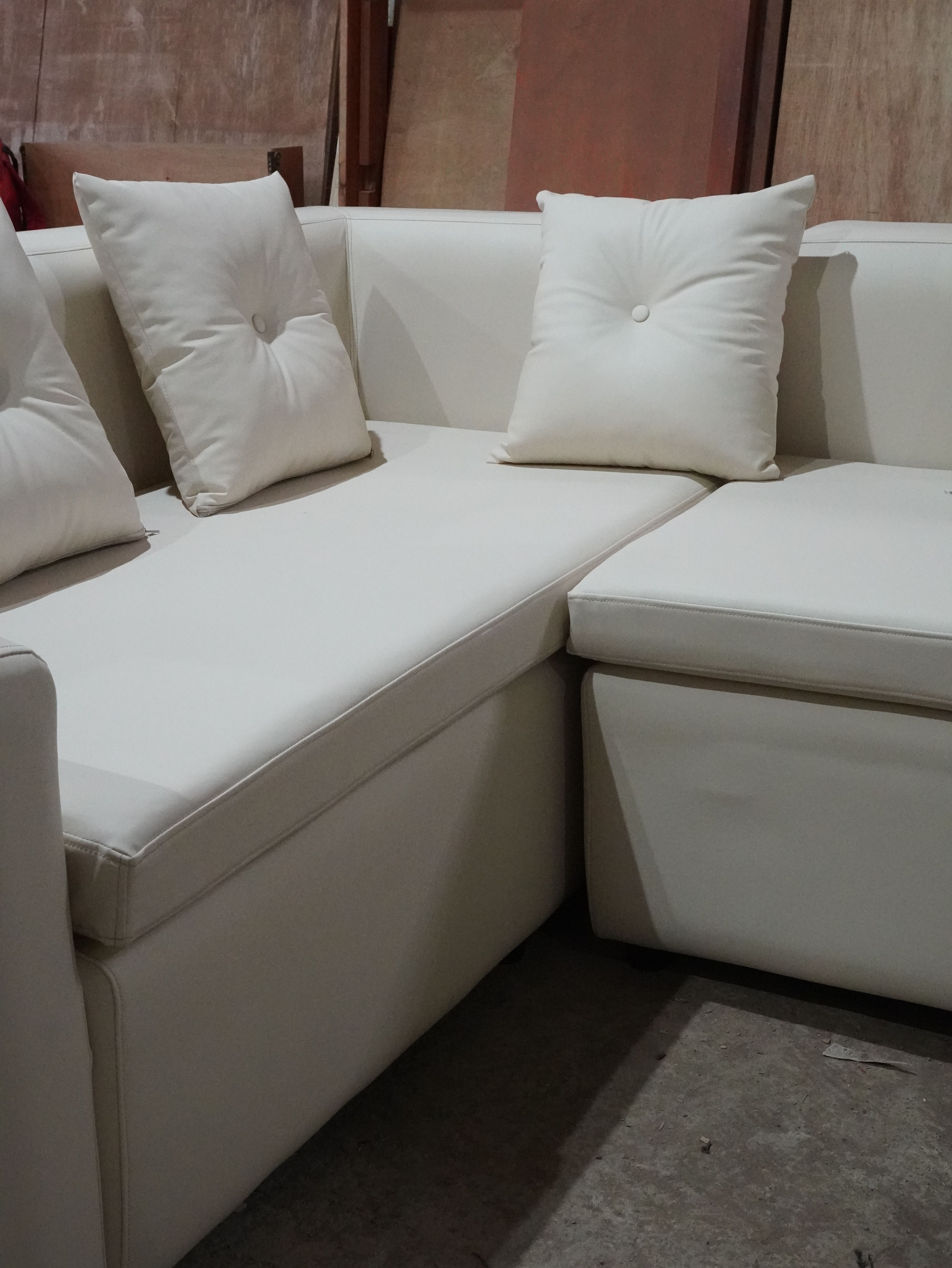 A premium leather L-shape sofa built on a kiln-dried mahogany frame, crafted for lasting comfort and refined style.