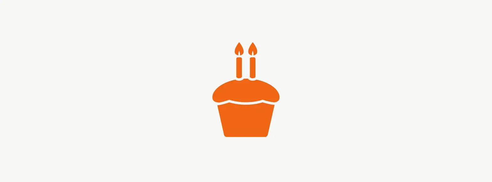 Illustration of cupcake with two candles celebrating second anniversary