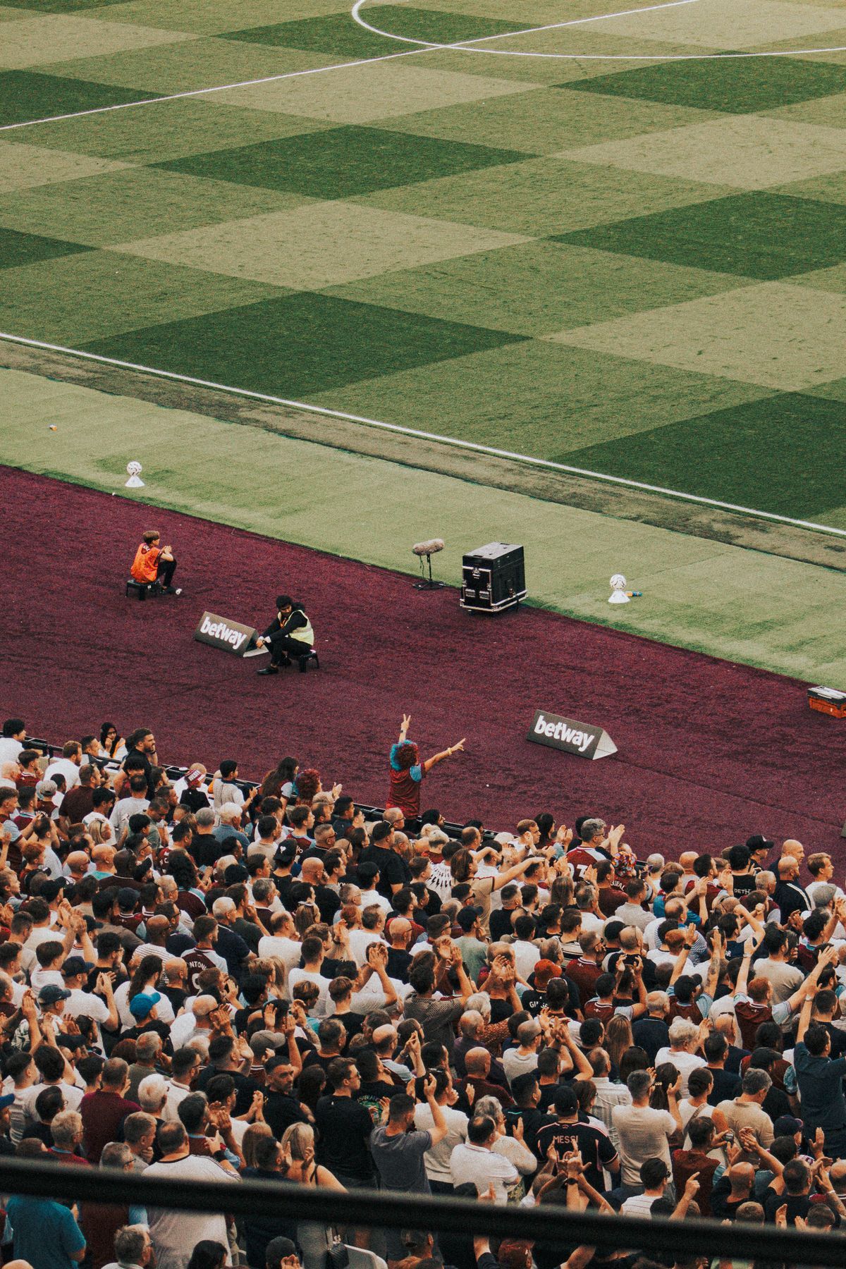Football supporters cheering together at London Stadium