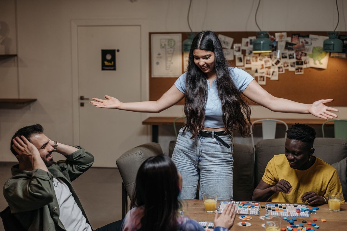 A group of friends laughing and playing a board game together