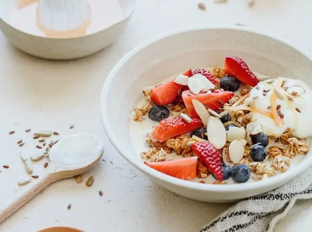 Bol de yogur con granola, fresas, arándanos, almendras y semillas
