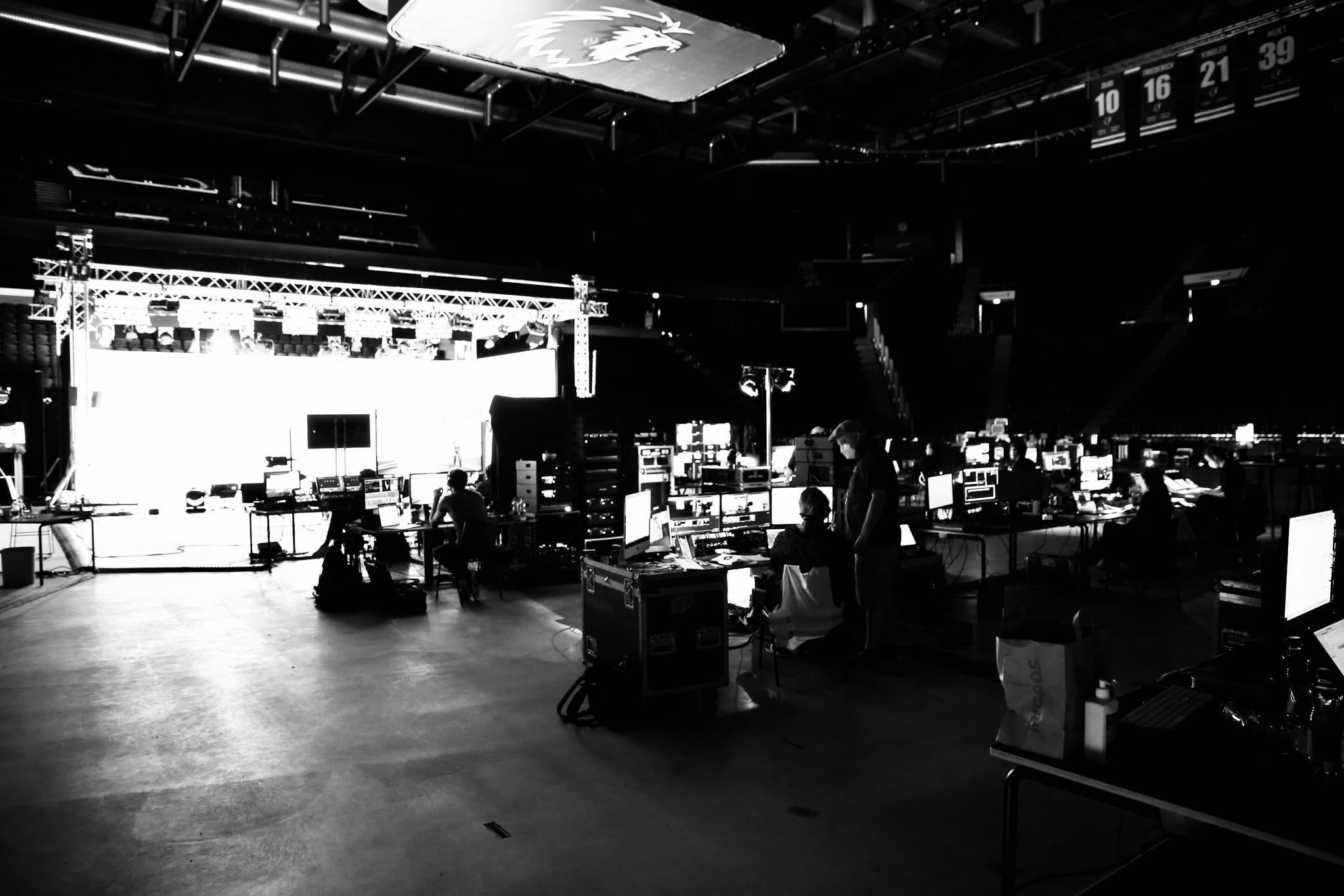 Many monitors face towards a soundstage and the technical crew operates them.