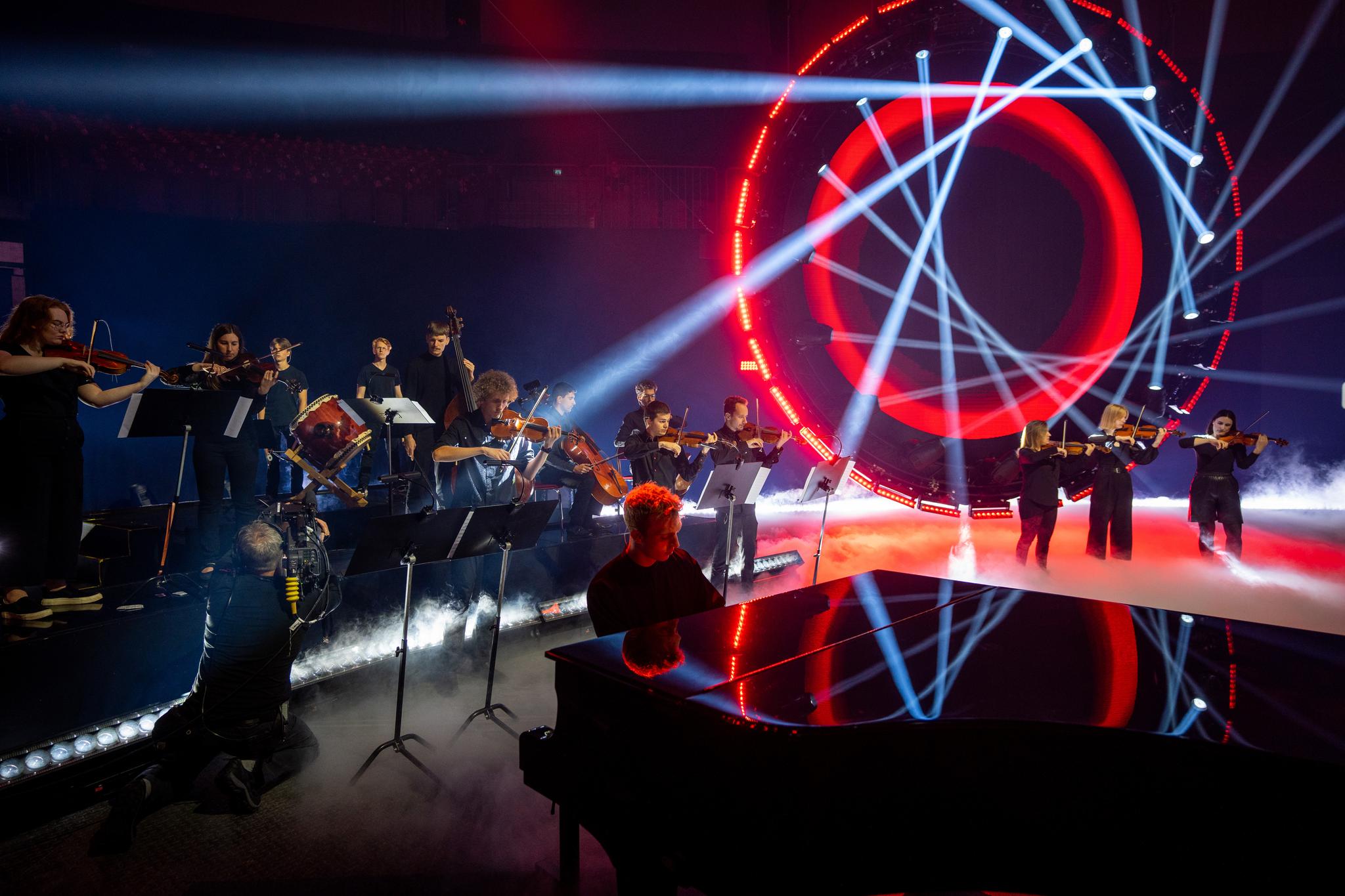 The 16 piece orchestra performs in front of the light installation.