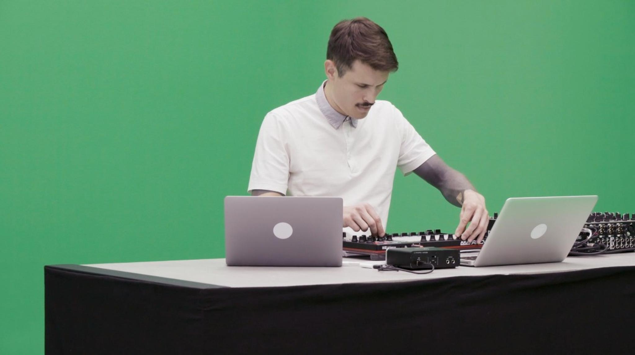 Alex.Do plays a live set on a green screen. He uses a launchpad, a mixer and 2 laptops.