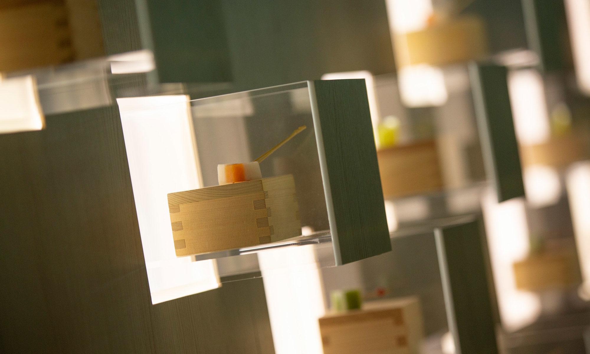 A wall of bamboo cubes house small, chic hors d'oeuvres.