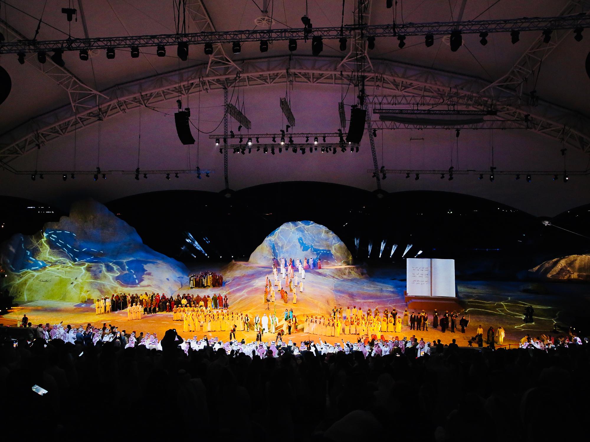 A wide shot of the large stage with projection mapping and large physical stage design.