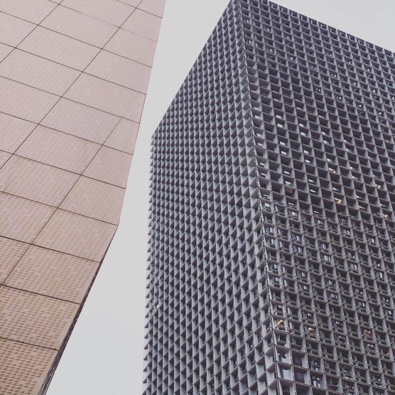 Two buildings come together in the frame creating stark lines and geometric figures.