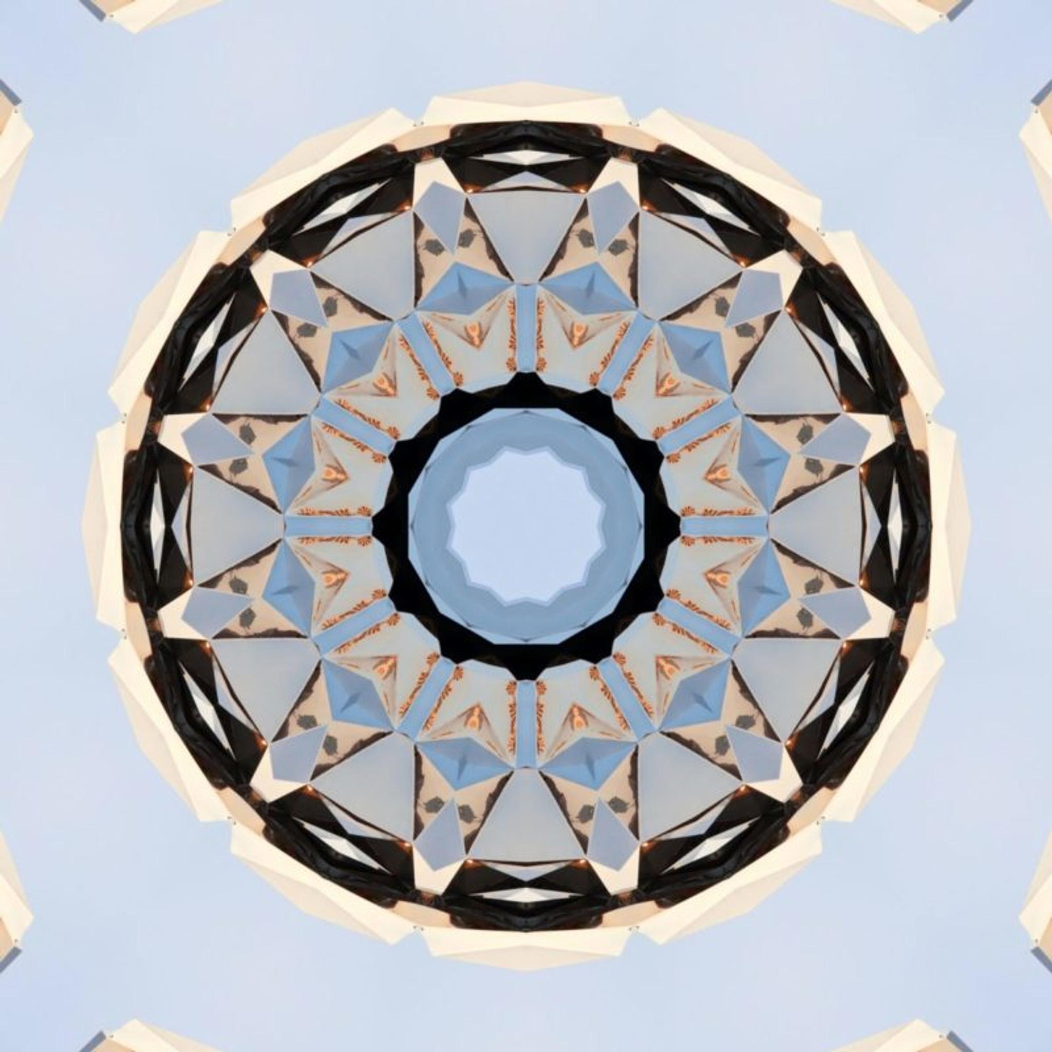 An NFT of a kaleidoscope of beige, sky blue and black.